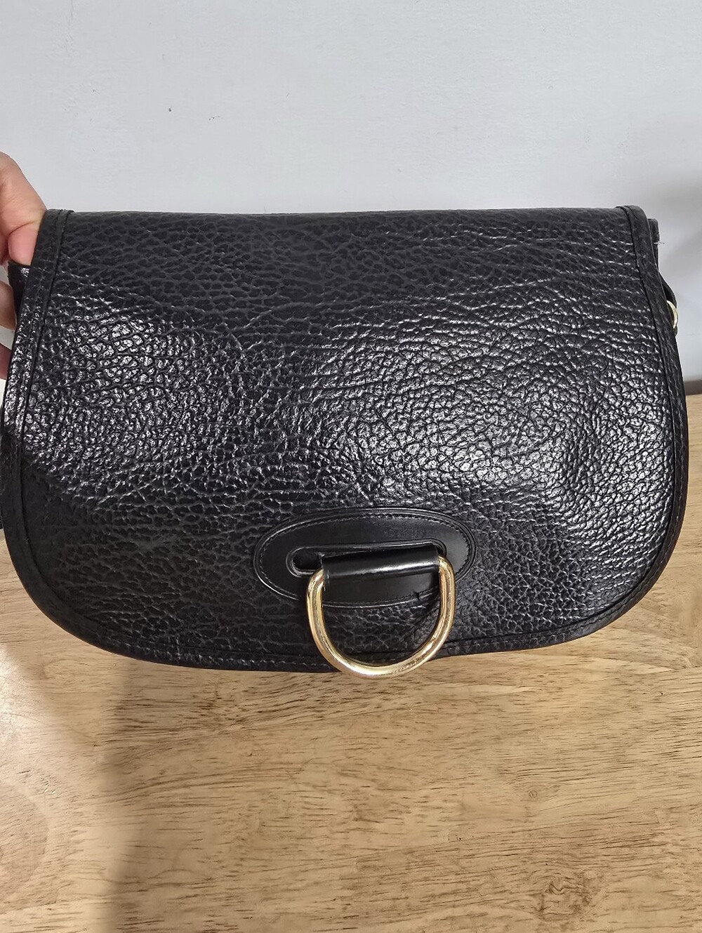 Black Pebbled Leather Crossbody Bag with Gold Ring Accent